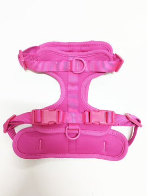 Soft padded dog harness in pink, flat top view showing dual leash rings